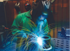 Industrial automation arm enhancing domestic machining supply chain resilience in a precision factory setting.