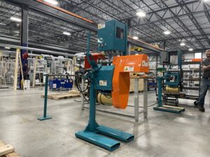 Industrial automation arm enhancing domestic machining supply chain resilience in a precision factory setting.